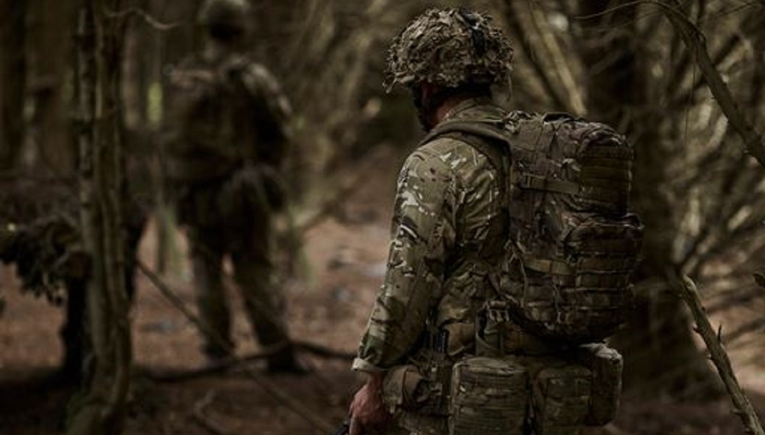 Soldiers walking through woodland