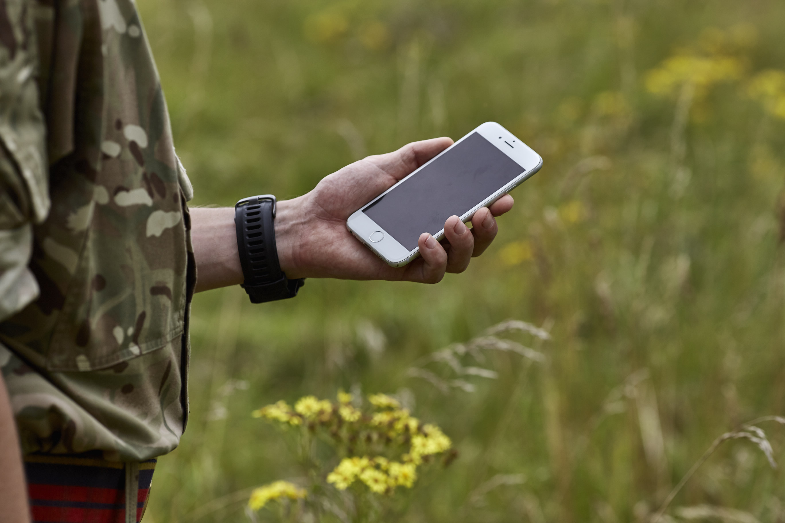 Iphone in hand in field
