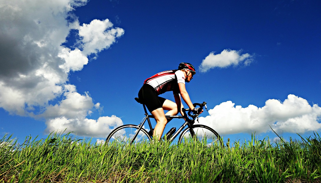 Road Cyclist next to long grass