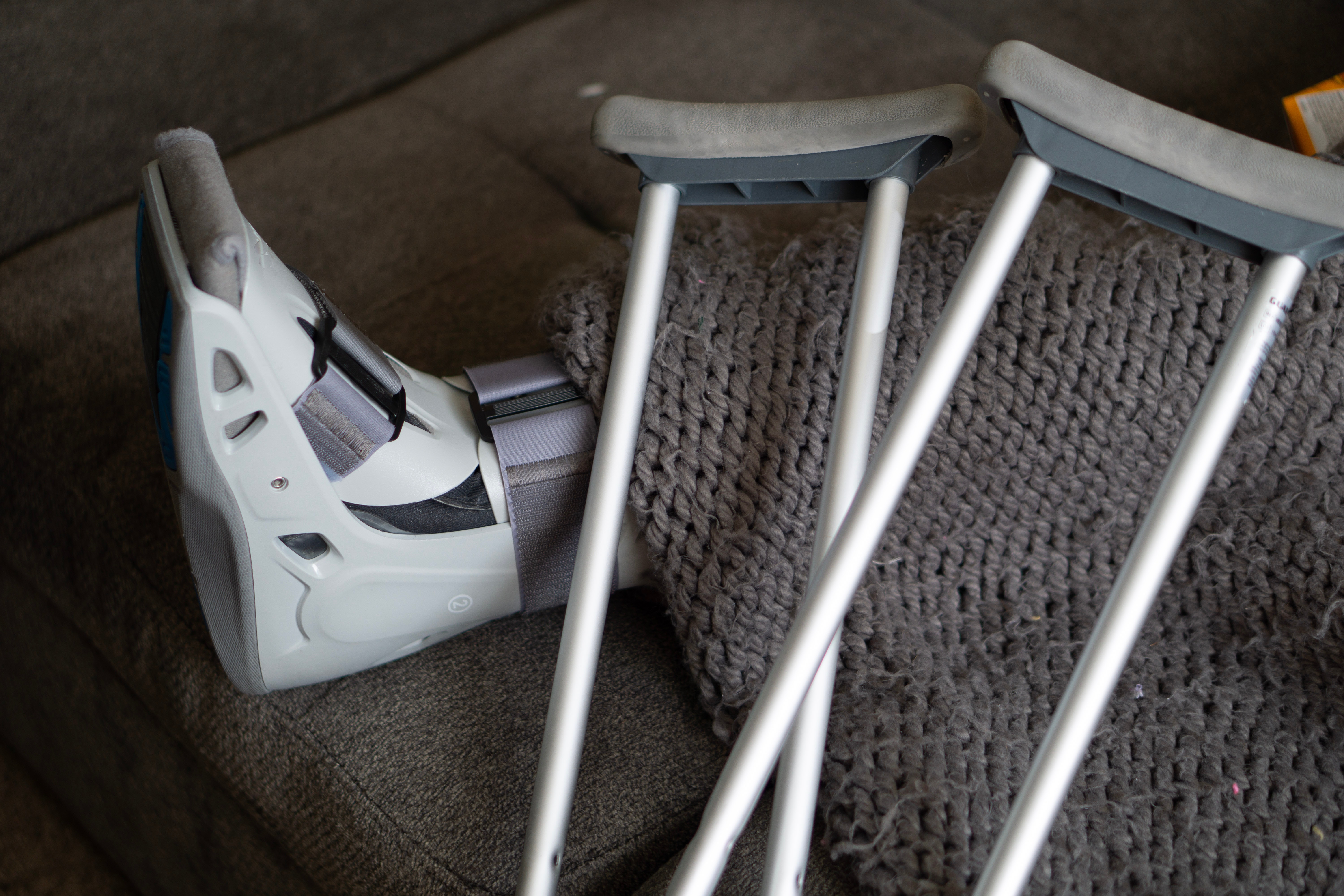 crutches resting on a broken leg