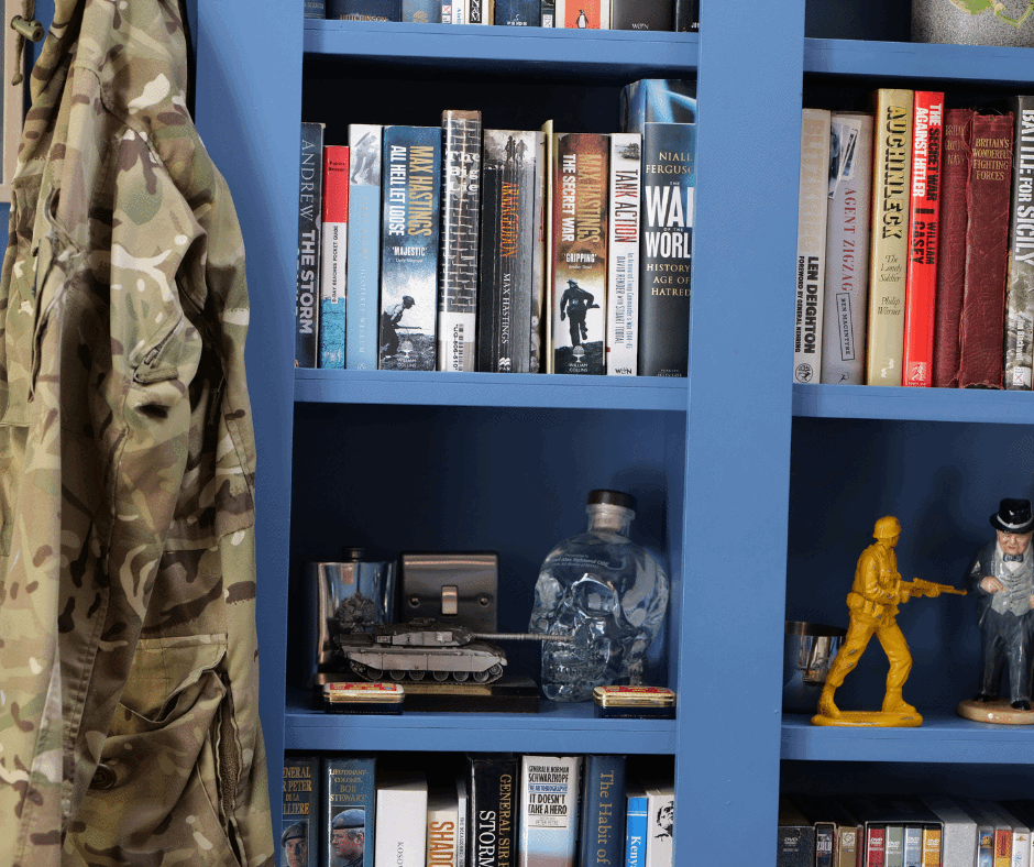 Military Home Insurance protects the contents on a veterans blue bookshelf.